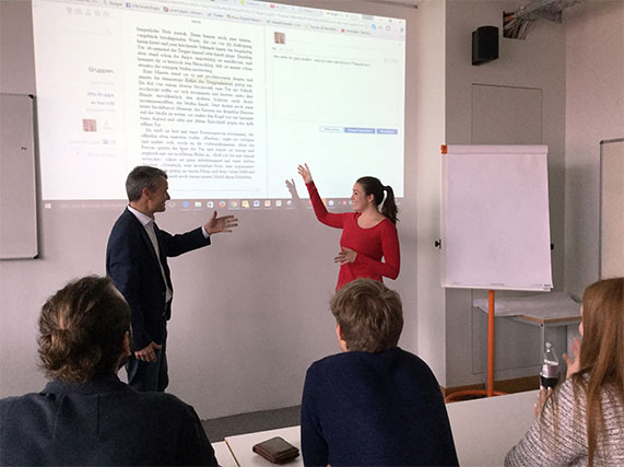 A girl and a man giving the presentation in a conference room.